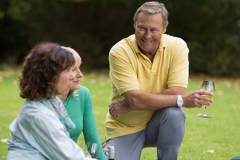 Friends with hearing loss and aids at picnic