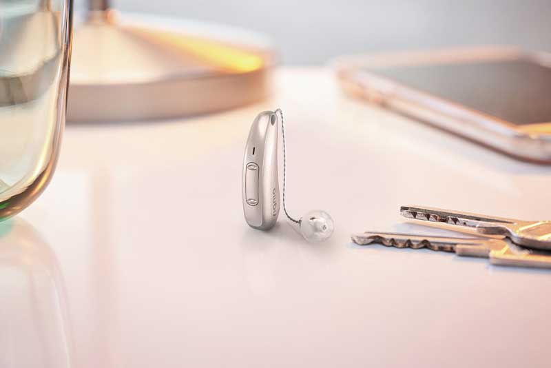 Signia Xperience Pure Charge&Go X hearing aid on table